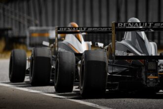 black and yellow f 1 car on road during daytime